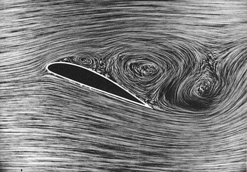 Photograph of an airfoil in a wind tunnel, showing separated flow over the top surface.